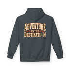 A dark heather hoodie shown from the back, featuring a large graphic print that reads 'ADVENTURE IS THE DESTINATION' in beige and orange lettering with a compass design.