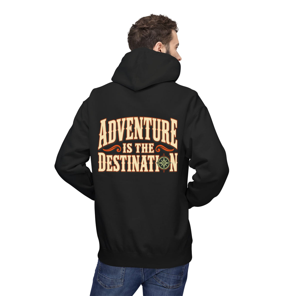 A man wearing a black pullover hoodie, viewed from the back. The hoodie features a large graphic print on the back in a western-style font that reads 'ADVENTURE IS THE DESTINATION' in tan and orange, with a small compass icon.