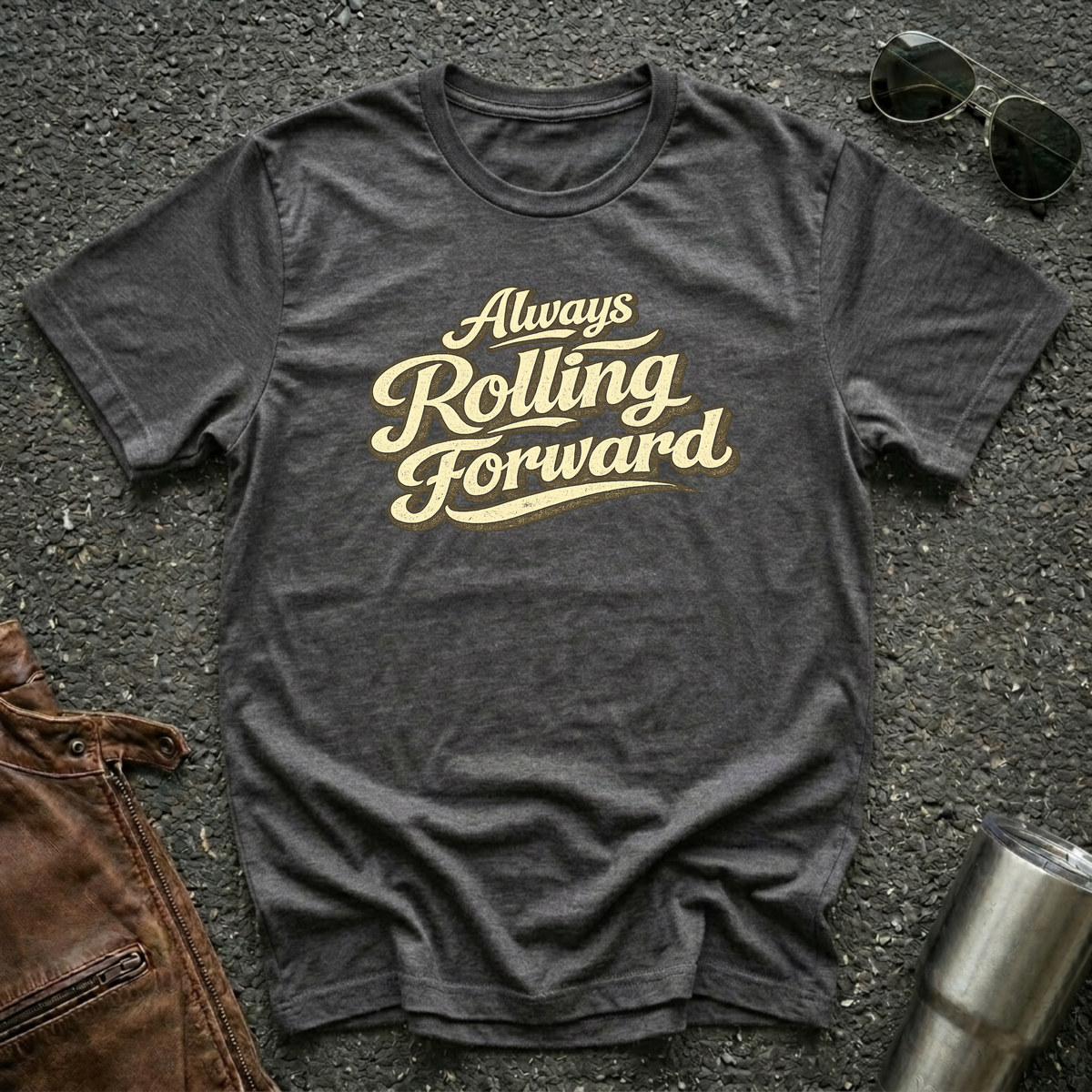 Dark heather 'Always Rolling Forward' road life T-shirt featuring vintage cream typography on a soft unisex tee.