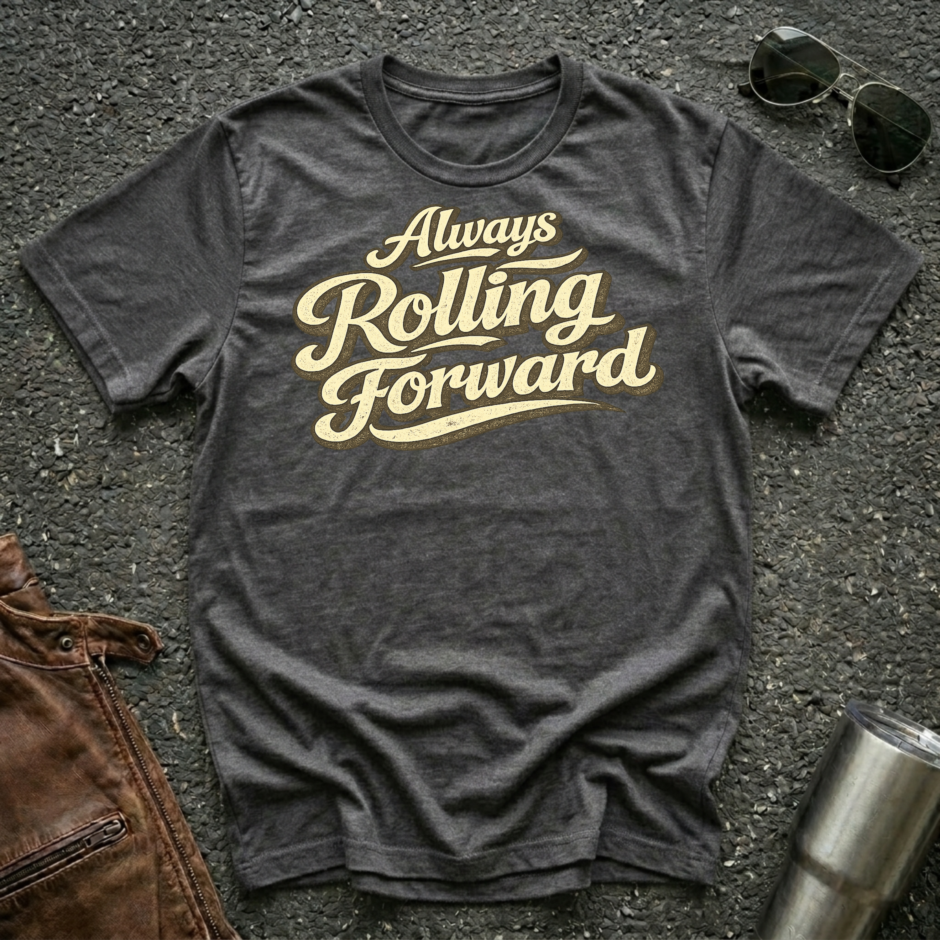 Dark heather 'Always Rolling Forward' road life T-shirt featuring vintage cream typography on a soft unisex tee.