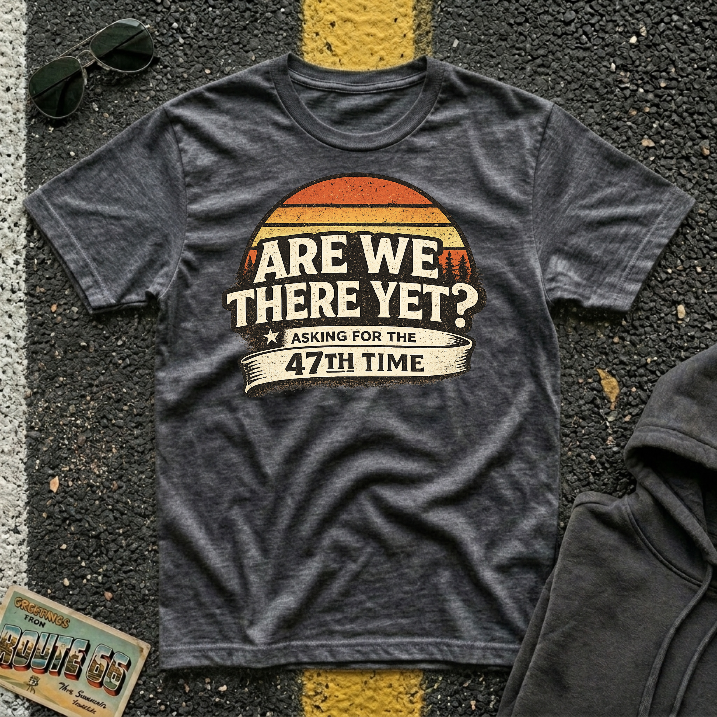 Are We There Yet? Asking for the 47th Time T-shirt by The Riverstone Life on a dark heather Gildan Softstyle 64000 featuring a humorous road trip design.
