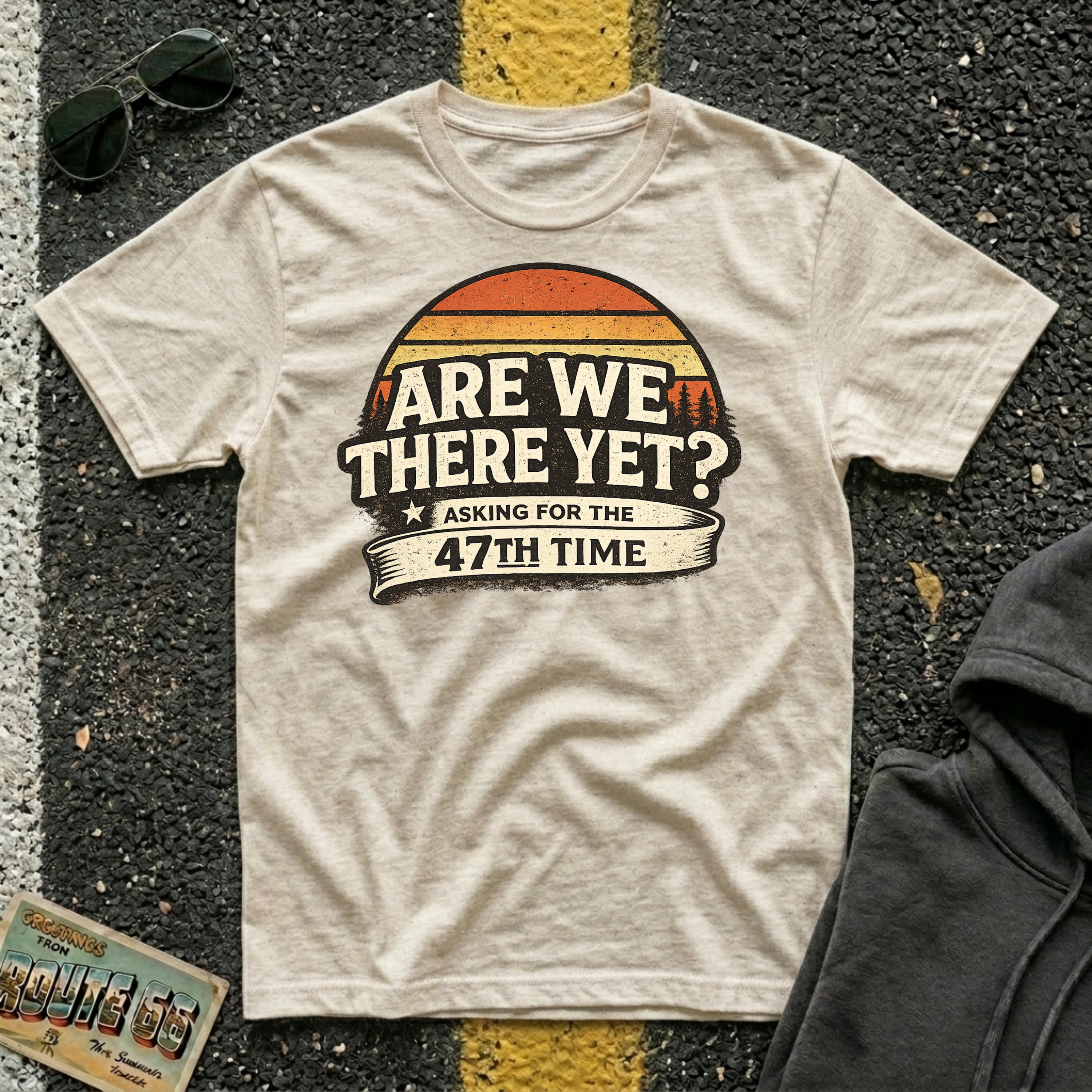 Are We There Yet? Asking for the 47th Time T-shirt by The Riverstone Life on a natural Gildan Softstyle 64000 featuring a humorous road trip design.
