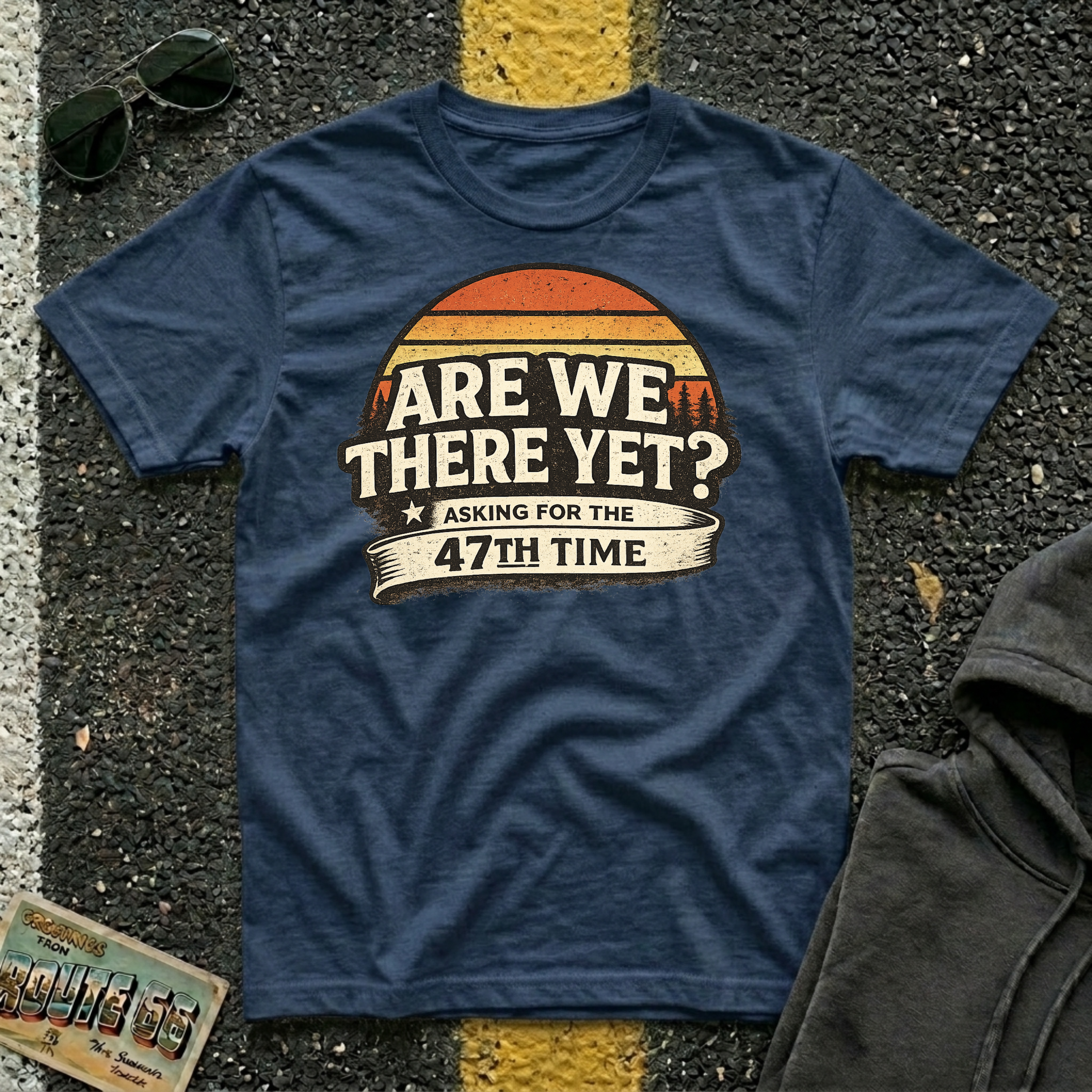 Are We There Yet? Asking for the 47th Time T-shirt by The Riverstone Life on a navy Gildan Softstyle 64000 featuring a humorous road trip design.