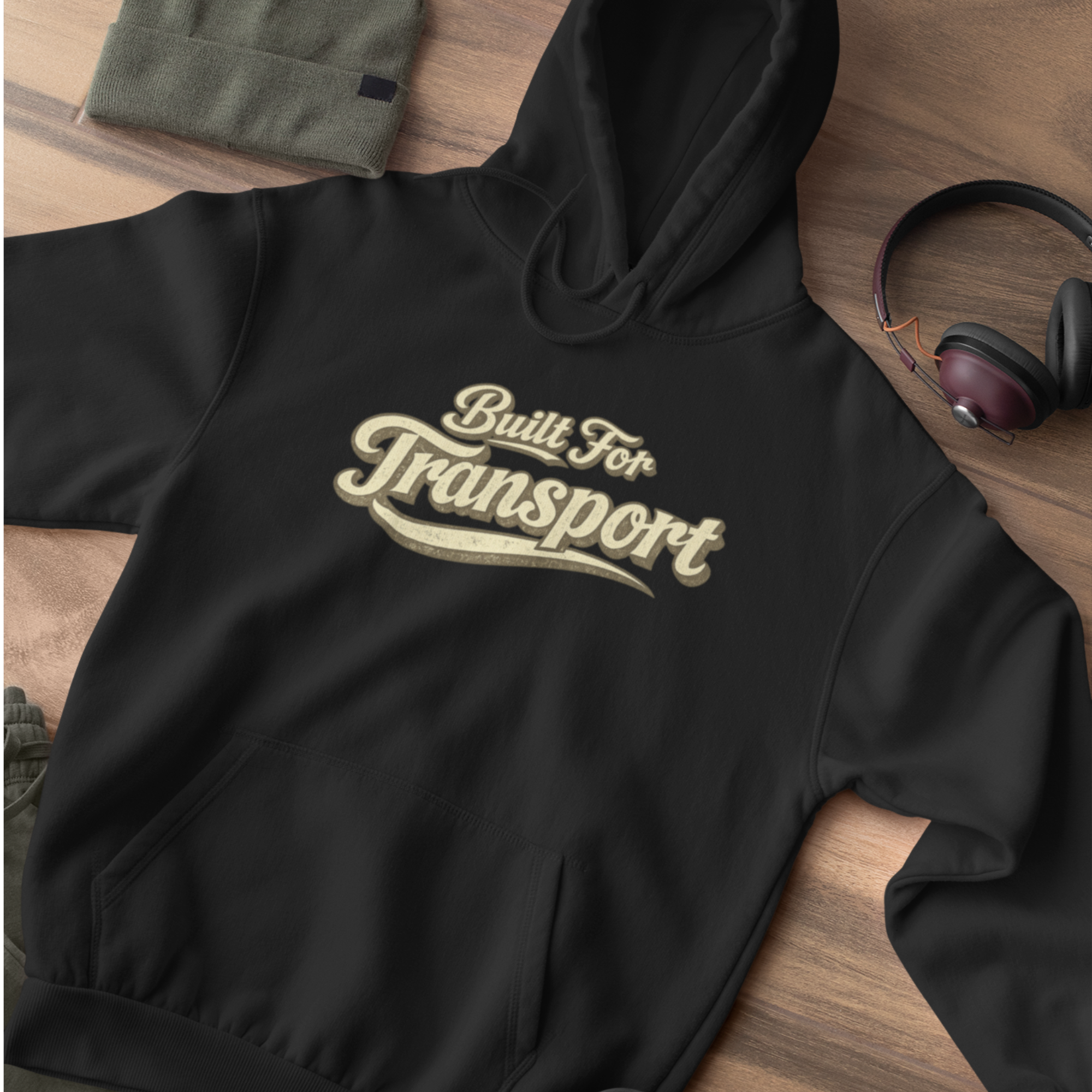 A black hoodie on a flat lay 'Built For Transport' 