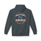 A dark heather hoodie shown from the back, featuring a circular graphic print with the text 'PAID TO TRAVEL AMERICA' 'THE ROAD IS THE JOB' and a blue map of the United States on a white background.
