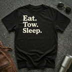 A black crewneck t-shirt with the text 'Eat. Tow. Sleep.'