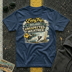 Every Trip Includes Unexpected Weather T-shirt by The Riverstone Life on a navy Gildan Softstyle 64000 featuring a vintage weather-themed highway design.