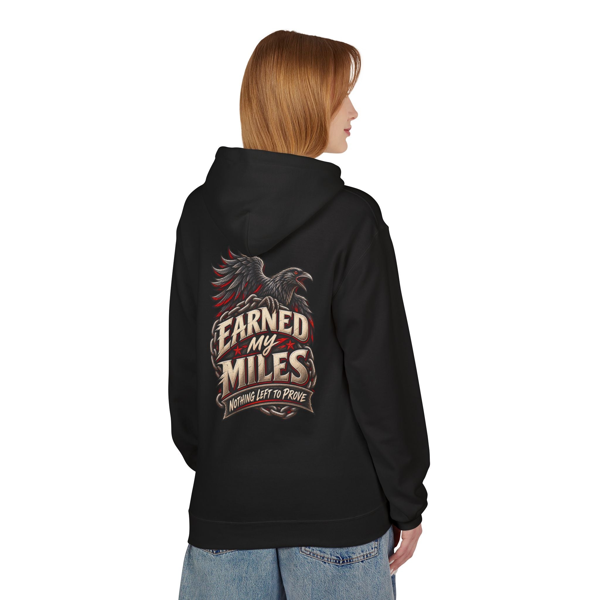 A woman shown from the back wearing a black hoodie with a large graphic on the back. The graphic features an eagle and the text 'Earned My Miles' and 'Nothing Left to Prove'.