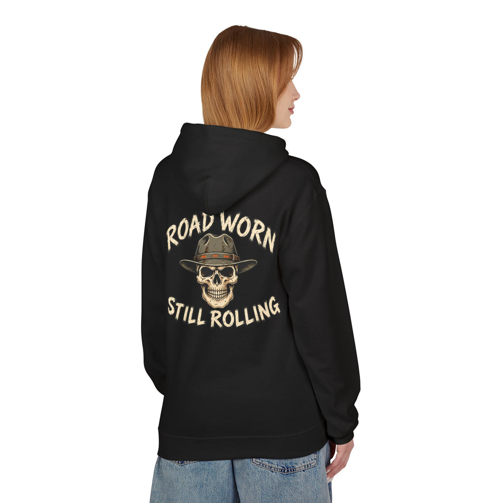 Person wearing a black hoodie with text on the back 'Road Worn Still Rolling' standing against a white background