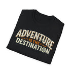 A folded black t-shirt with a vintage-style graphic that reads 'ADVENTURE IS THE DESTINATION' in cream and orange lettering, displayed on a clean white background.