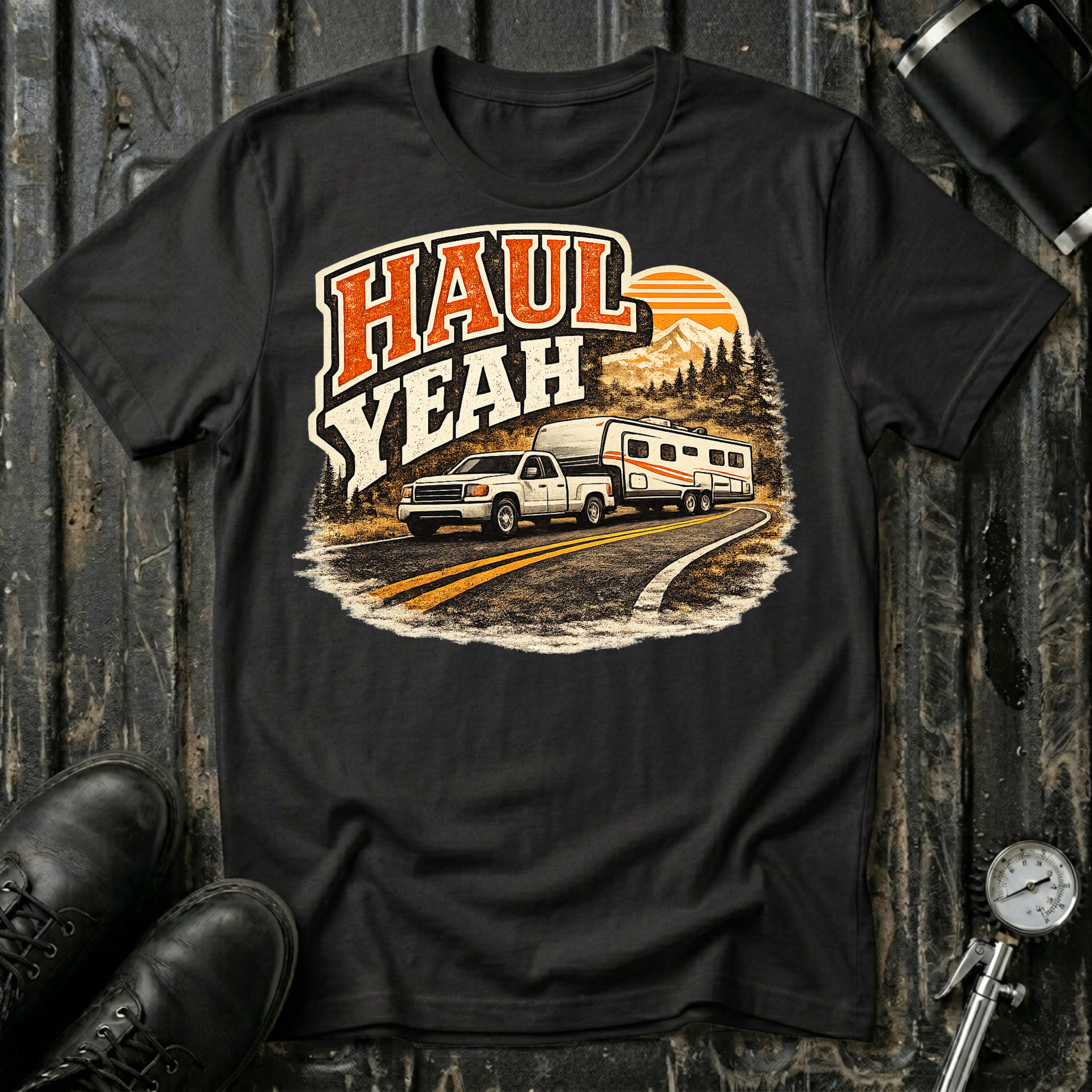 Haul Yeah RV Transport T-shirt by The Riverstone Life on a black Gildan Softstyle 64000 featuring a pickup truck towing a fifth-wheel RV.