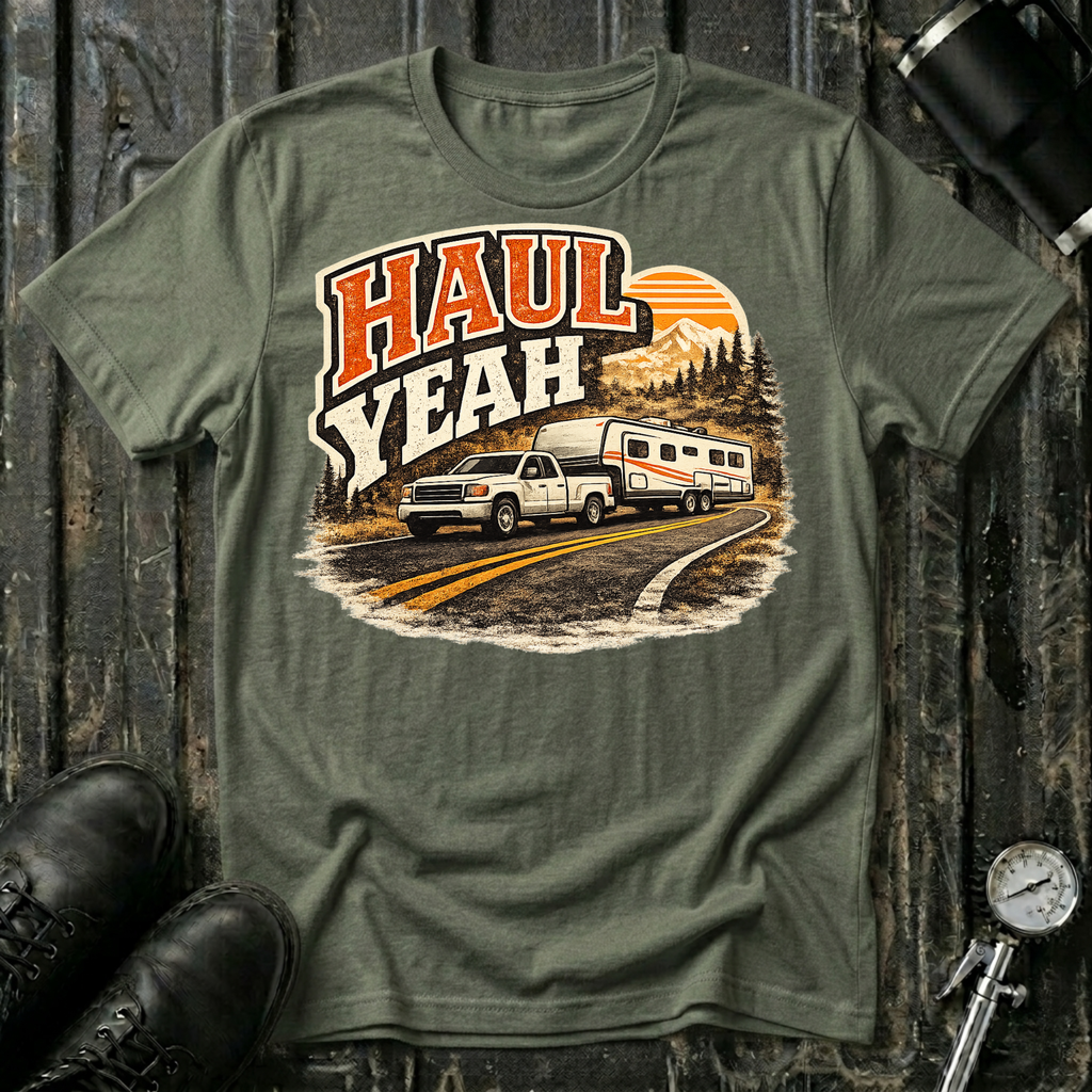 Haul Yeah RV Transport T-shirt by The Riverstone Life on a military green Gildan Softstyle 64000 featuring a pickup truck towing a fifth-wheel RV.