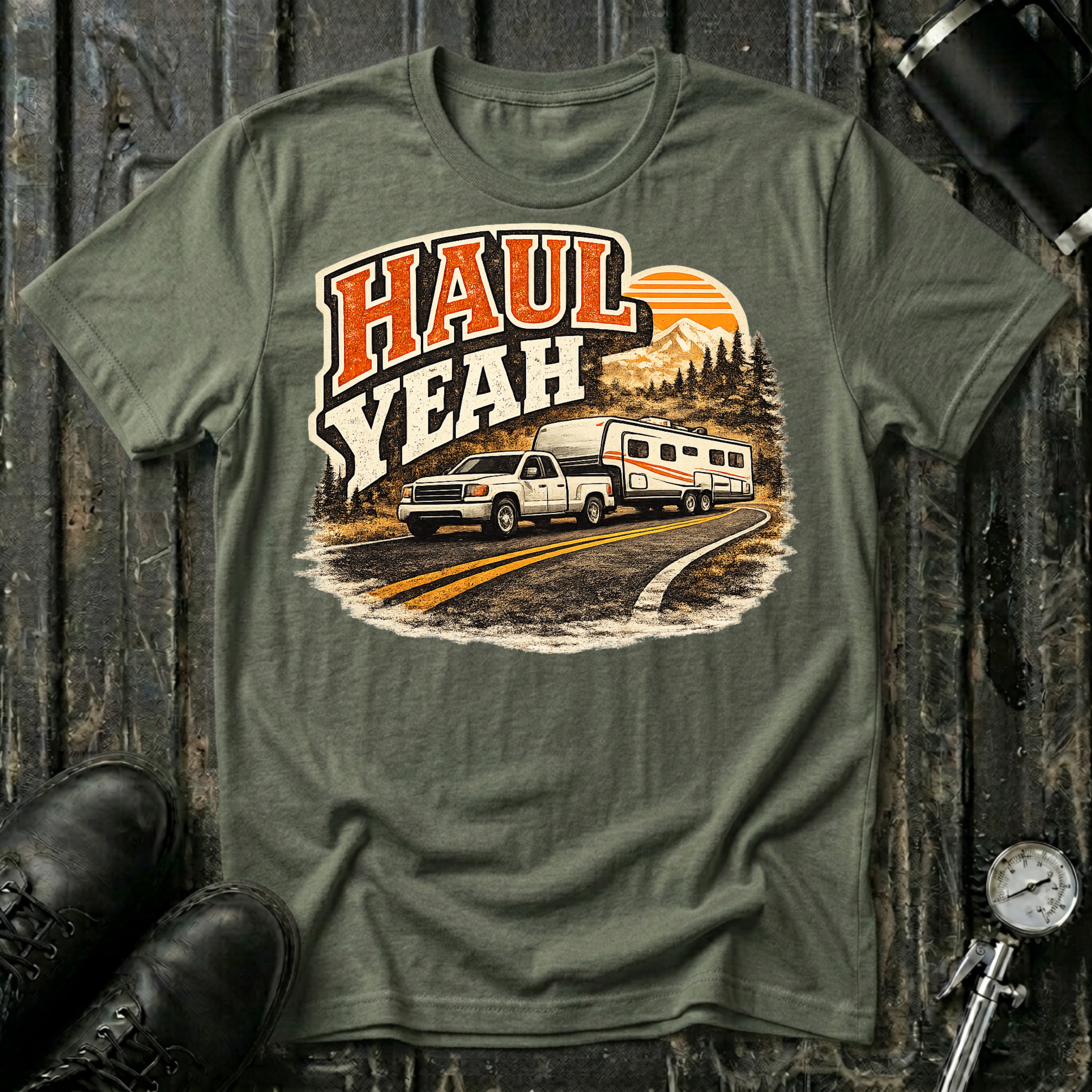 Haul Yeah RV Transport T-shirt by The Riverstone Life on a military green Gildan Softstyle 64000 featuring a pickup truck towing a fifth-wheel RV.