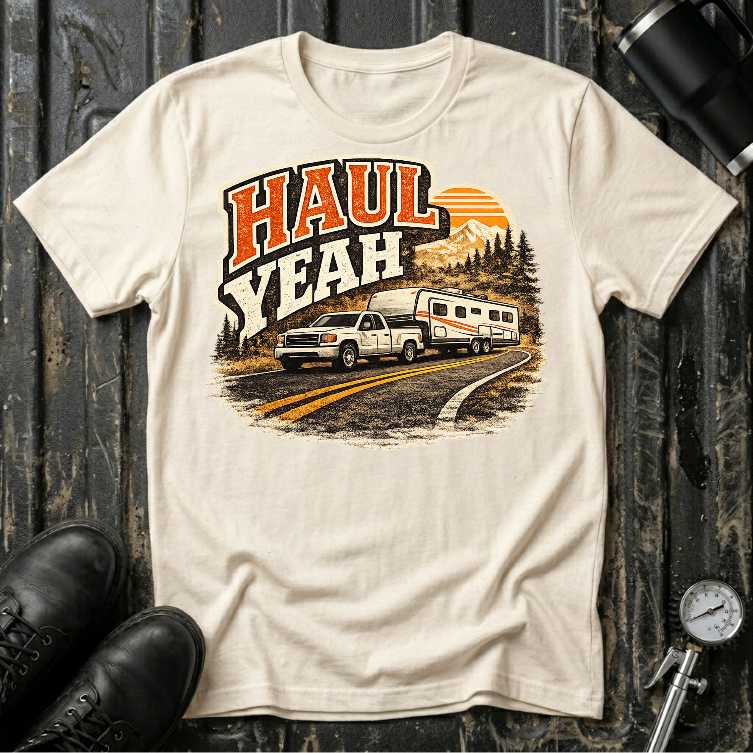 Haul Yeah RV Transport T-shirt by The Riverstone Life on a natural Gildan Softstyle 64000 featuring a pickup truck towing a fifth-wheel RV.