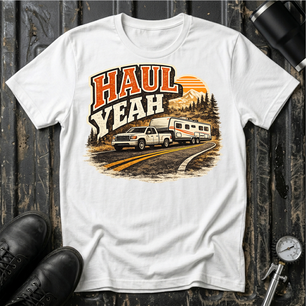 Haul Yeah RV Transport T-shirt by The Riverstone Life on a white Gildan Softstyle 64000 featuring a pickup truck towing a fifth-wheel RV.