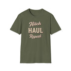 Military green t-shirt with 'Hitch Haul Repeat' typography vintage style on a white background.