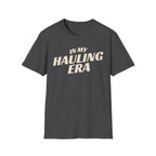 Dark heather 'In My Hauling Era' road life t-shirt featuring bold cream typography on a soft unisex tee.
