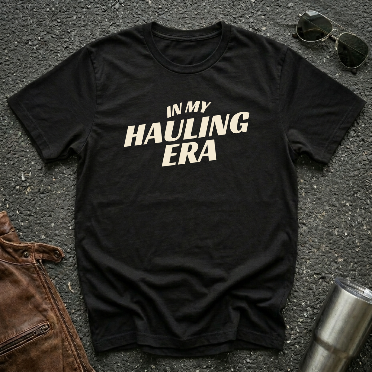 Black 'In My Hauling Era' road life t-shirt featuring bold cream typography on a soft unisex tee.