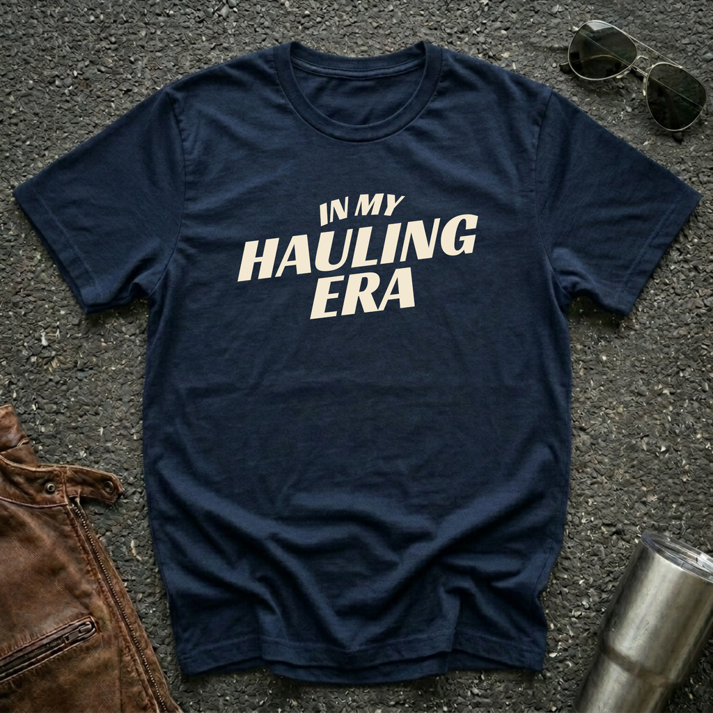 Navy 'In My Hauling Era' road life t-shirt featuring bold cream typography on a soft unisex tee.