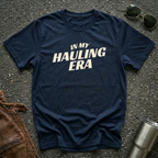 Navy 'In My Hauling Era' road life t-shirt featuring bold cream typography on a soft unisex tee.