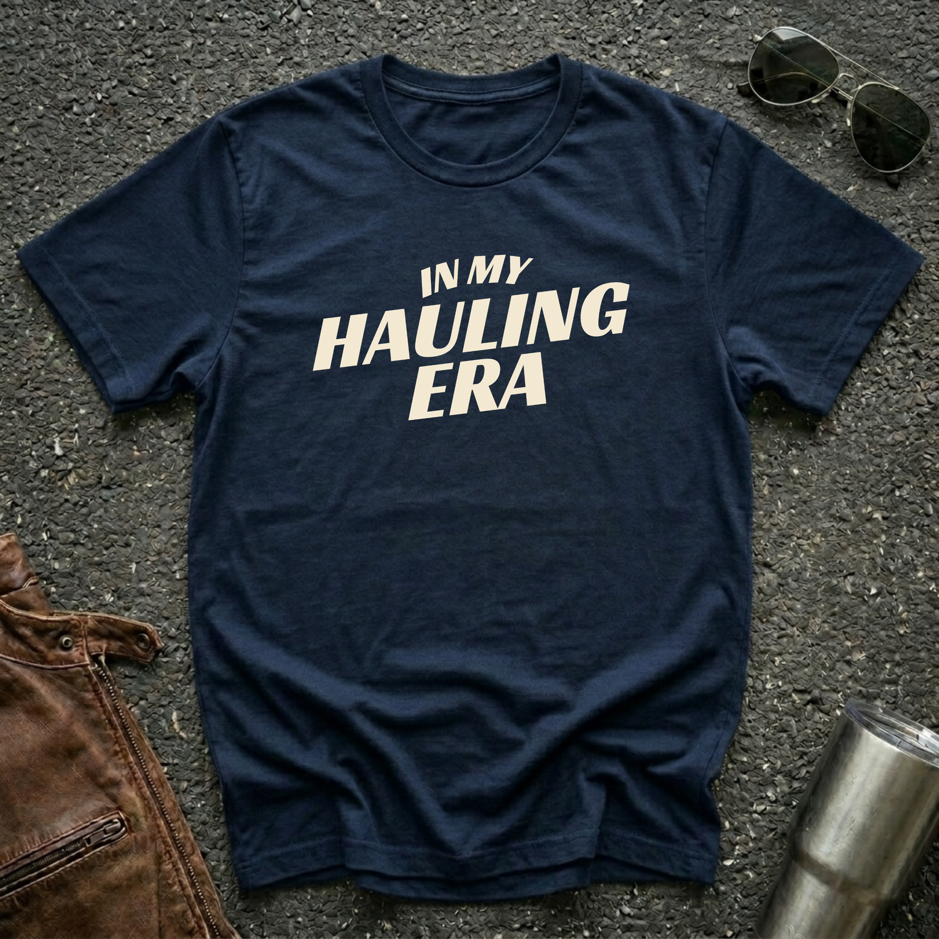 Navy 'In My Hauling Era' road life t-shirt featuring bold cream typography on a soft unisex tee.