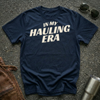 Navy 'In My Hauling Era' road life t-shirt featuring bold cream typography on a soft unisex tee.