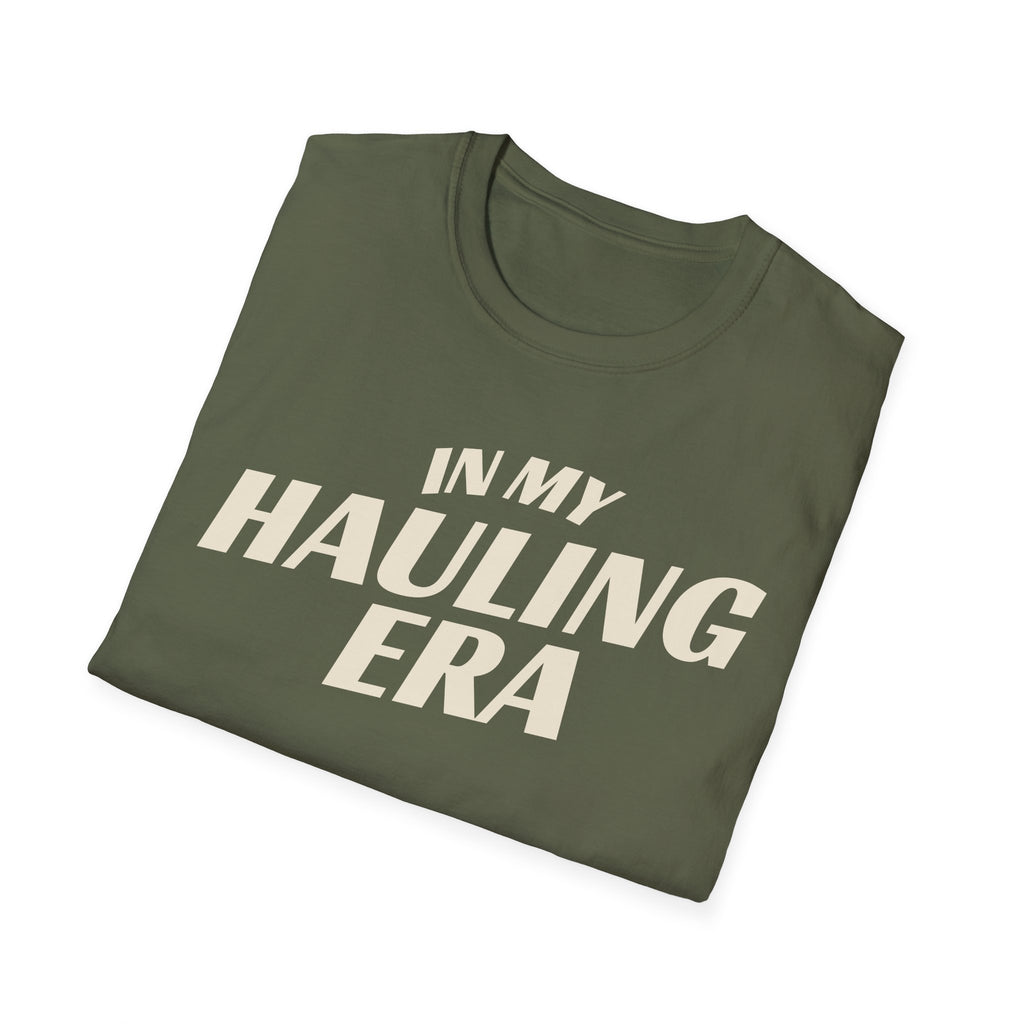 Folded military green 'In My Hauling Era' road life t-shirt featuring bold cream typography on a soft unisex tee.
