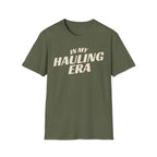 Military green 'In My Hauling Era' road life t-shirt featuring bold cream typography on a soft unisex tee.
