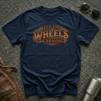 Navy 'Keep The Wheels Earning Vintage' RV Transport T-shirt featuring vintage gold and rust typography on a soft unisex tee.