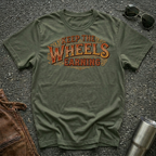 Military green 'Keep The Wheels Earning Vintage' RV Transport T-shirt featuring vintage gold and rust typography on a soft unisex tee.