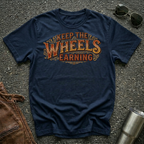Navy 'Keep The Wheels Earning' Vintage RV Transport T-shirt featuring vintage gold and rust typography on a soft unisex tee.