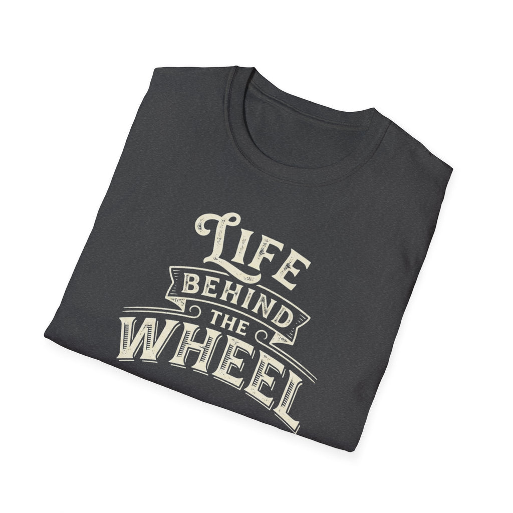 A dark heather short-sleeve t-shirt with a distressed cream graphic reading 'LIFE BEHIND THE WHEEL' folded white background