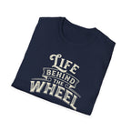 A navy short-sleeve t-shirt with a distressed cream graphic reading 'LIFE BEHIND THE WHEEL' folded white background
