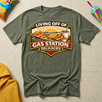Living Off of Gas Station Delicacies T-shirt by The Riverstone Life on a military green Gildan Softstyle 64000 featuring a vintage gas station food graphic with pizza, hot dogs, taquitos, and coffee.