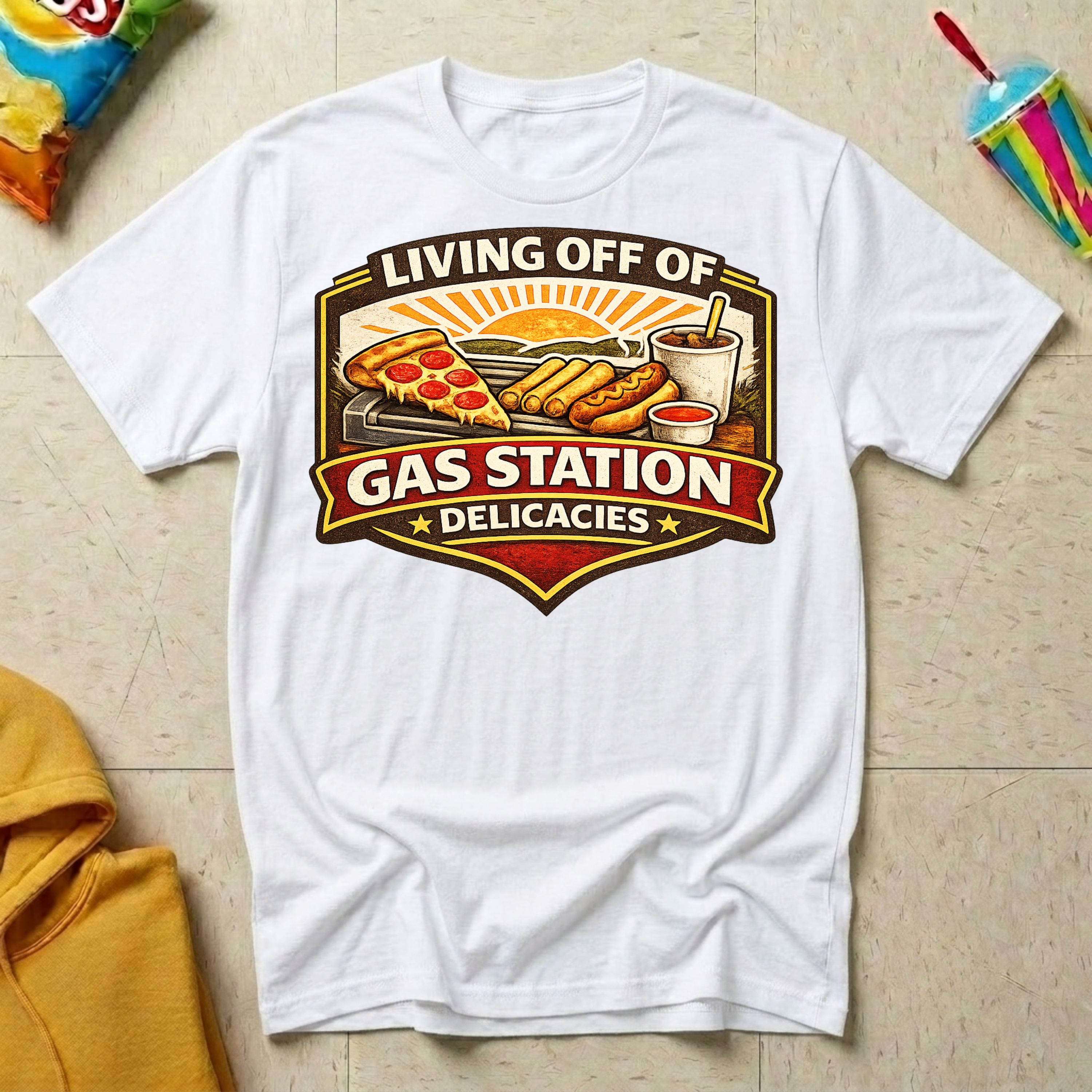 Living Off of Gas Station Delicacies T-shirt by The Riverstone Life on a white Gildan Softstyle 64000 featuring a vintage gas station food graphic with pizza, hot dogs, taquitos, and coffee.