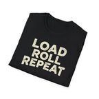 A folded black t-shirt with the phrase 'LOAD ROLL REPEAT' printed in a distressed cream-colored font, displayed on a clean white background.