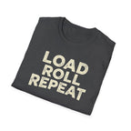 A folded dark heather t-shirt with the words 'LOAD ROLL REPEAT' printed in a distressed cream-colored font, shown on a plain white background.
