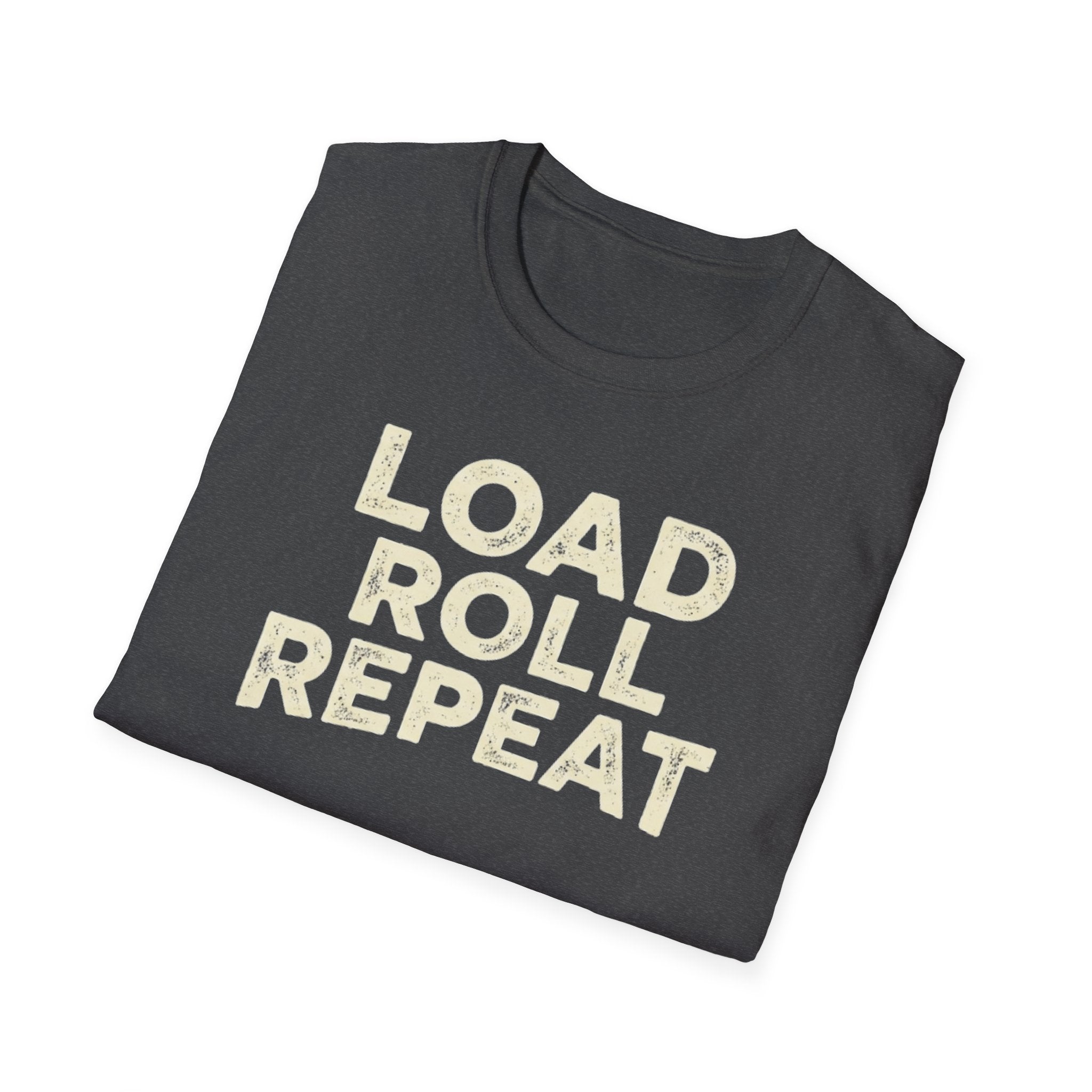 A folded dark heather t-shirt with the words 'LOAD ROLL REPEAT' printed in a distressed cream-colored font, shown on a plain white background.