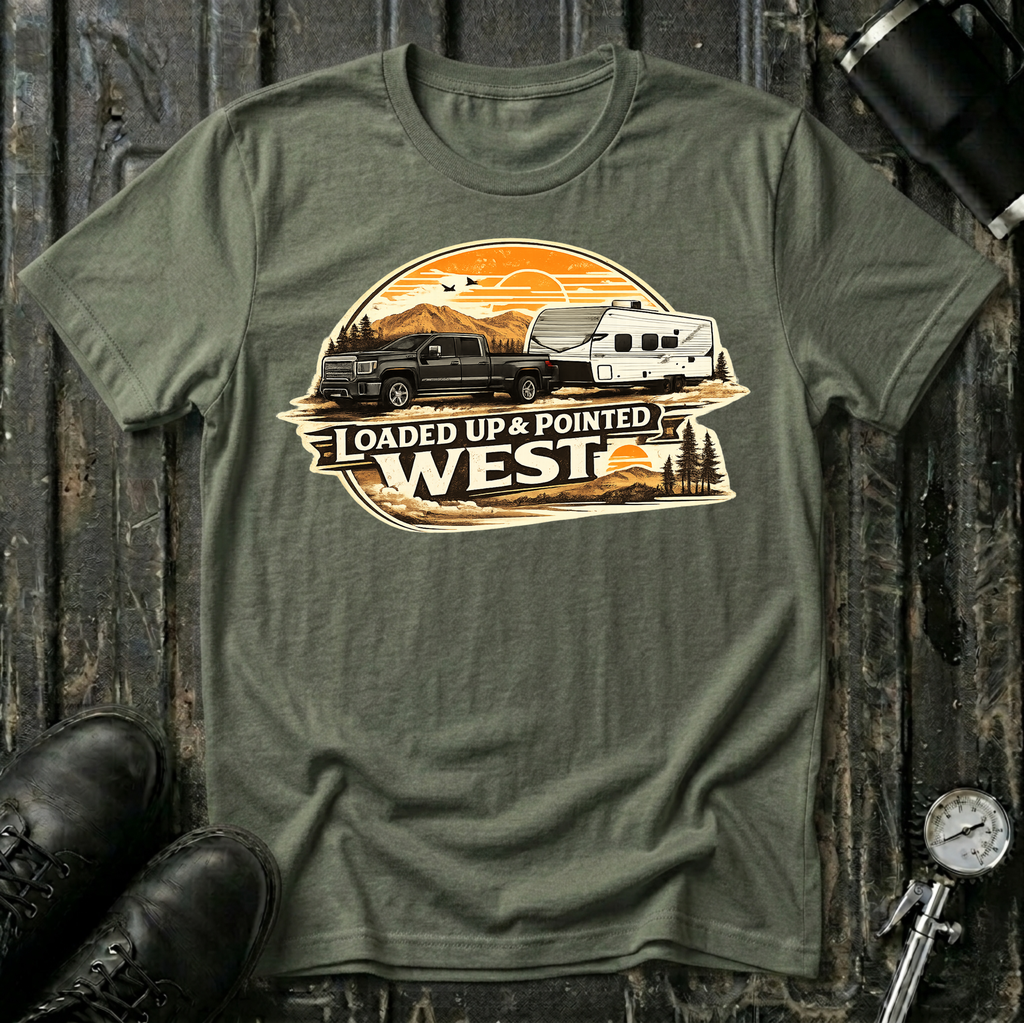 Loaded Up & Pointed West T-shirt by The Riverstone Life on a military green Gildan Softstyle 64000 featuring a pickup truck towing a camper toward a western sunset.