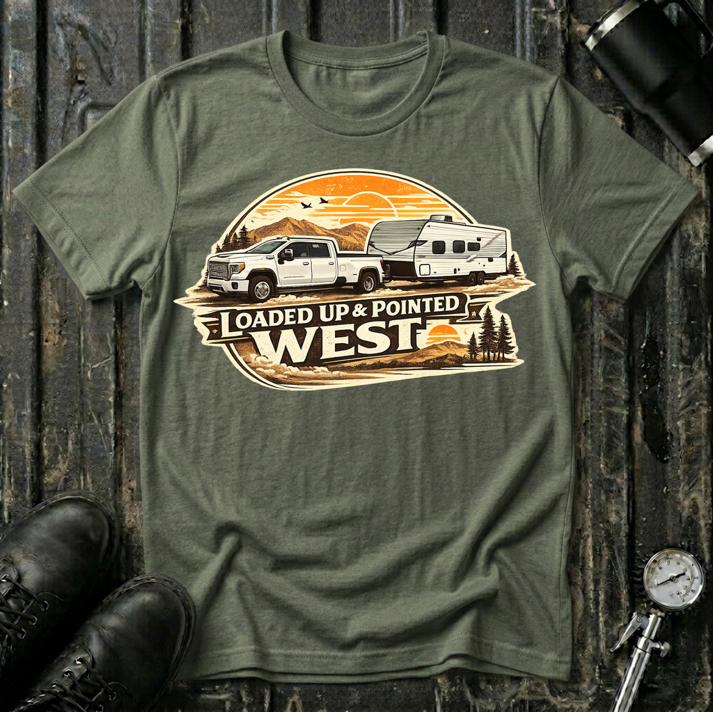 Loaded Up & Pointed West T-shirt by The Riverstone Life on a military green Gildan Softstyle 64000 featuring a pickup truck towing a camper toward a western sunset.