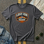 Dark heather road trip t-shirt featuring a vintage mountain badge with the phrase "Lost-ish Again"