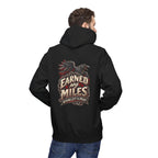 Person wearing a black hoodie with a white graphic on the back, standing against a white background 'Earned My Miles Nothing Left to Prove"