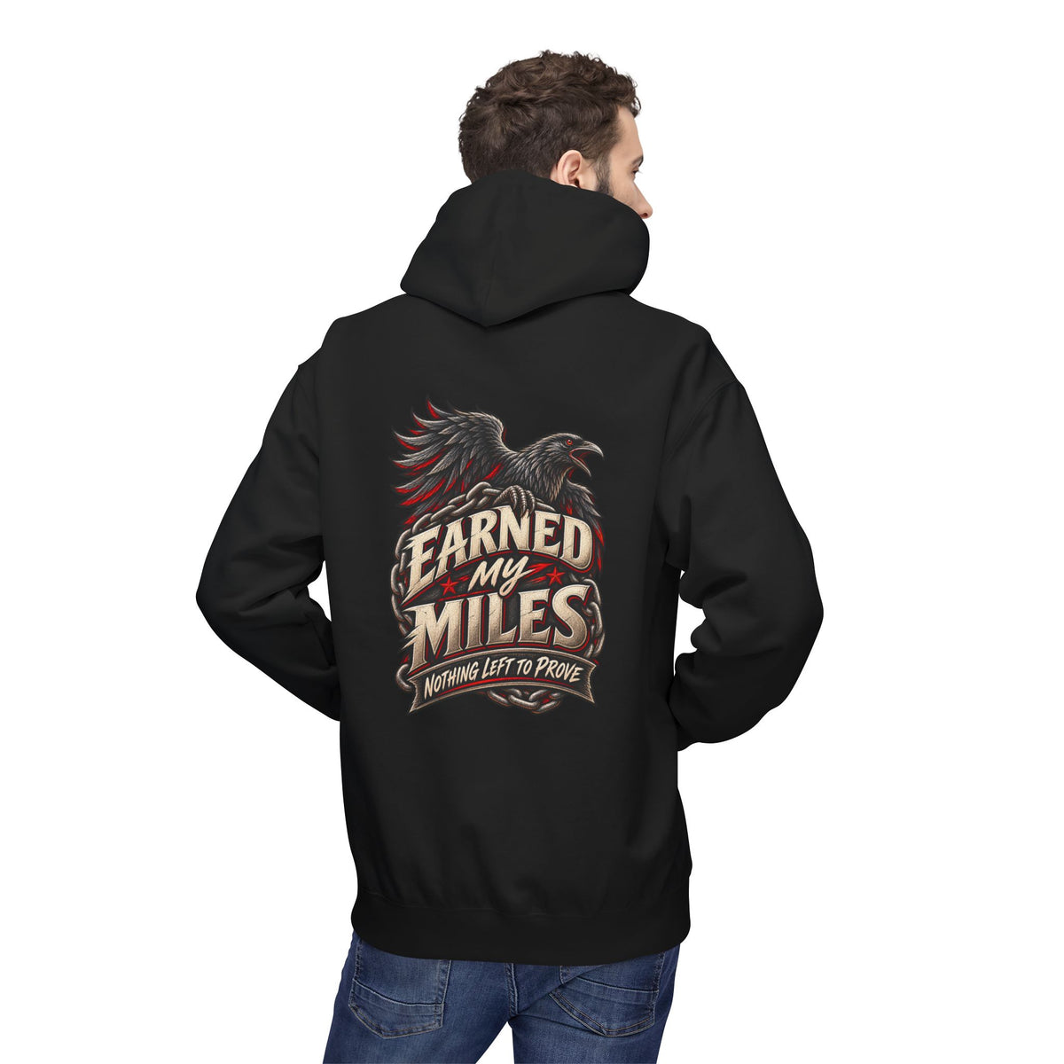 Person wearing a black hoodie with a white graphic on the back, standing against a white background 'Earned My Miles Nothing Left to Prove"