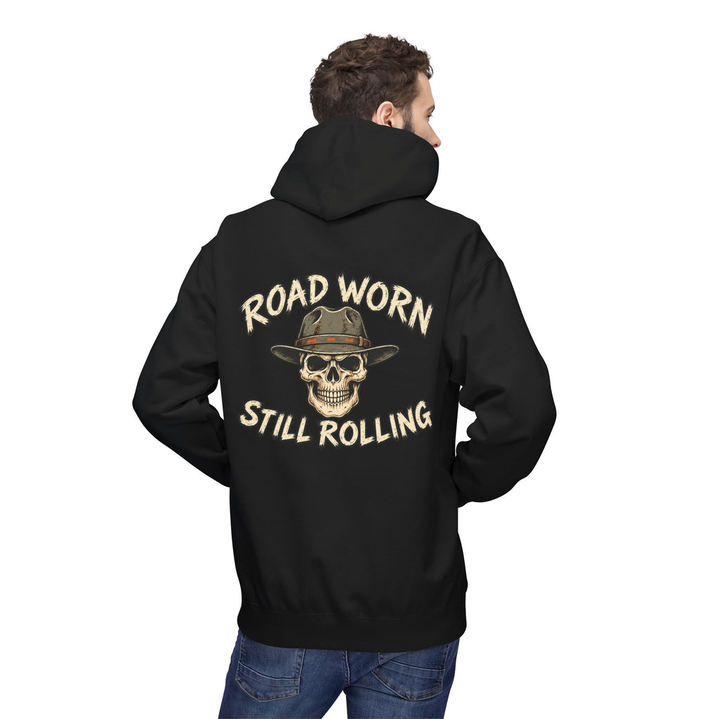 Male model wearing a black hoodie with text on the back 'Road Worn Still Rolling' standing against a white background