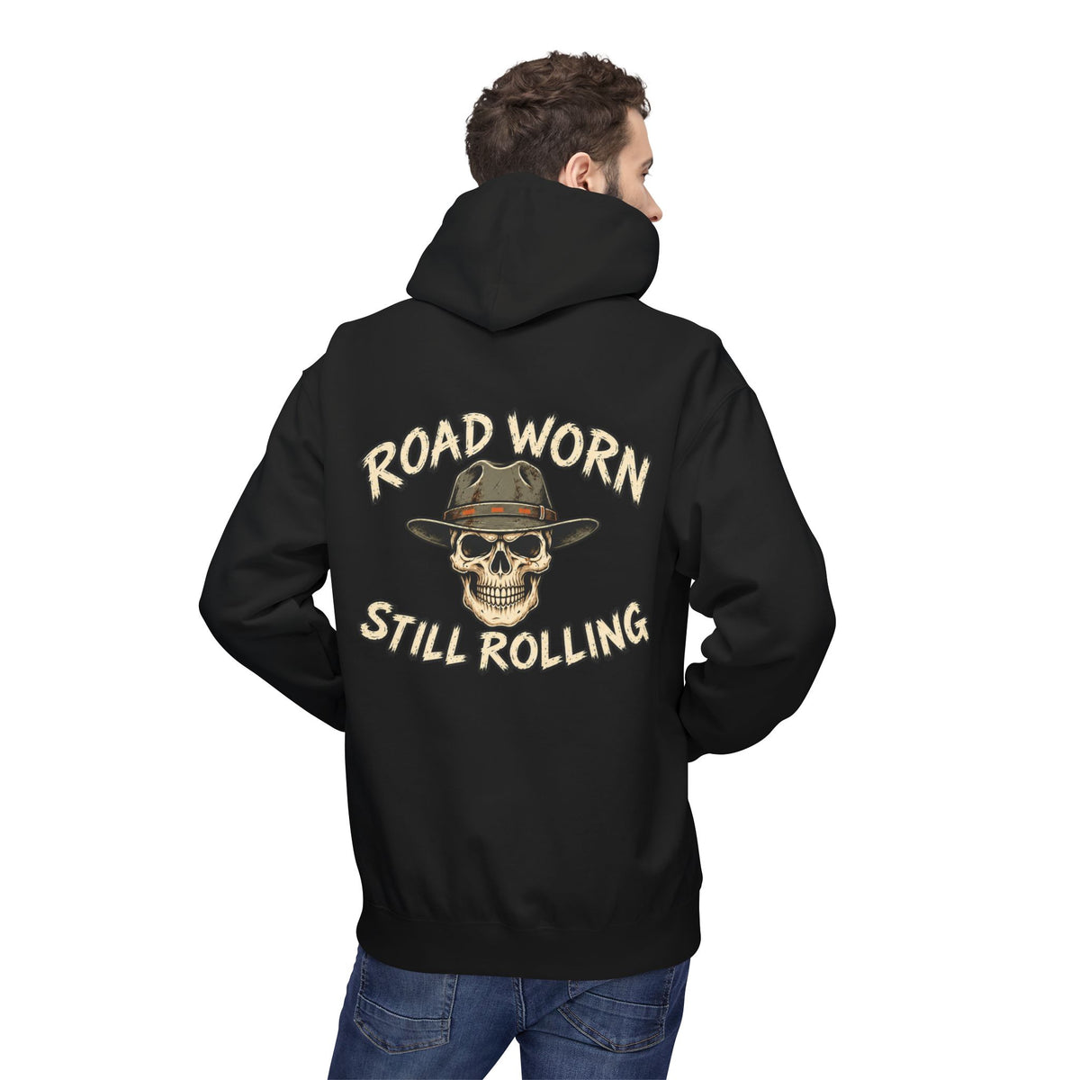 Male model wearing a black hoodie with text on the back 'Road Worn Still Rolling' standing against a white background