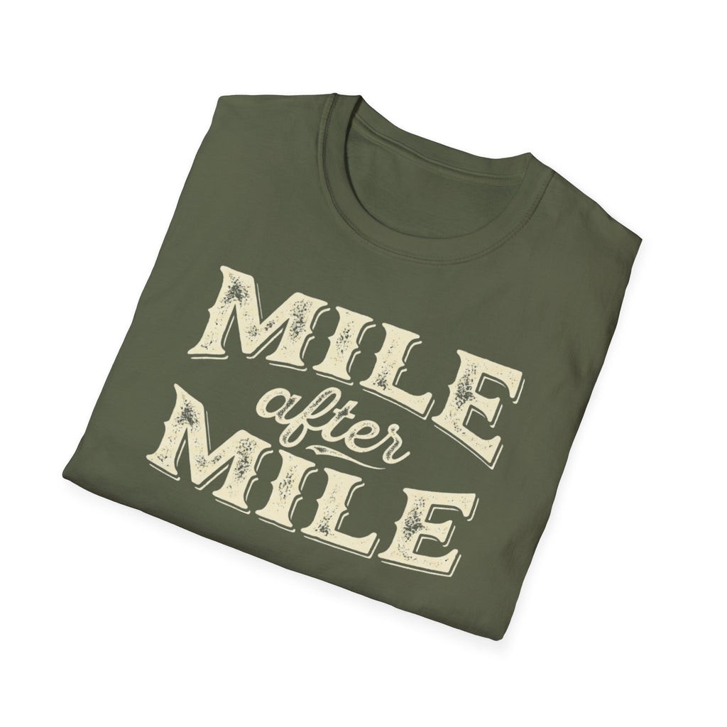 Military green folded 'Mile After mile' t-shirt with a white background.