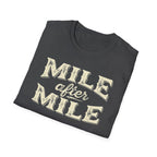 Dark heather folded 'Mile After mile' t-shirt with a white background.