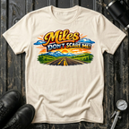 Miles Don't Scare Me! T-shirt by The Riverstone Life on a natural Gildan Softstyle 64000 featuring a colorful open highway and mountain landscape design.