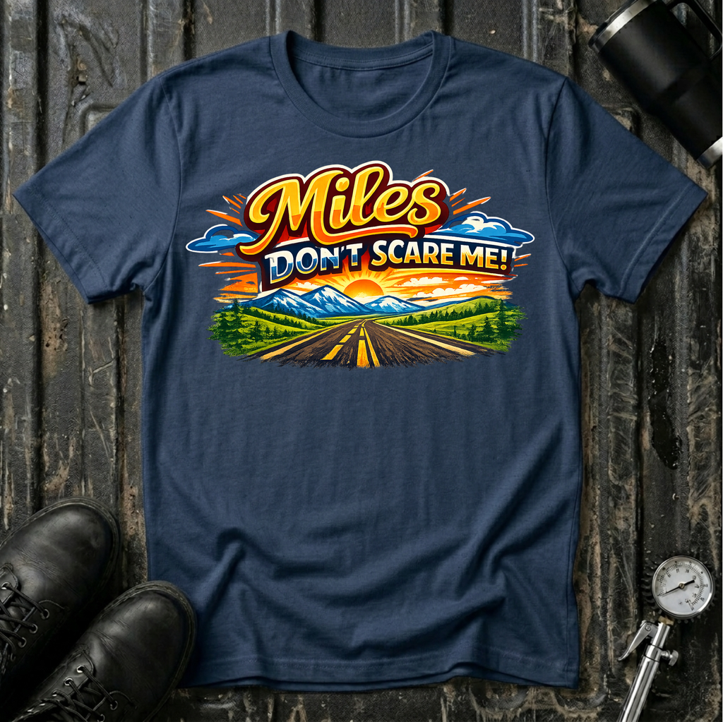 Miles Don't Scare Me! T-shirt by The Riverstone Life on a navy Gildan Softstyle 64000 featuring a colorful open highway and mountain landscape design.