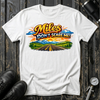Miles Don't Scare Me! T-shirt by The Riverstone Life on a white Gildan Softstyle 64000 featuring a colorful open highway and mountain landscape design.